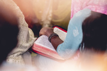 Woman reading a Bible at a small church in India.