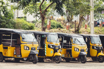 Yellow three-wheeled taxis in Vizag Visakhapatnam, India.