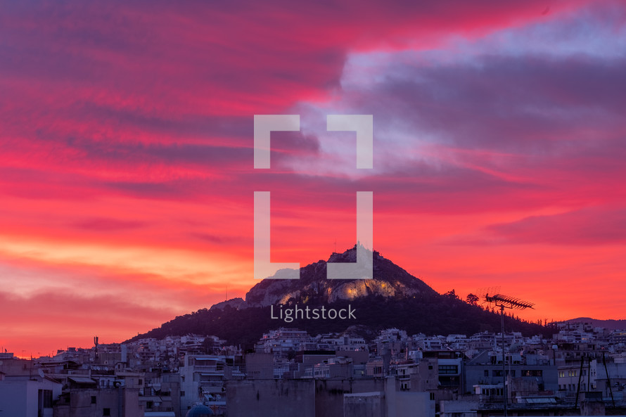 vibrant red sky over a town in Greece 
