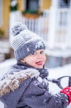 a toddler playing in snow 