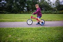 a child on a training bicycle 