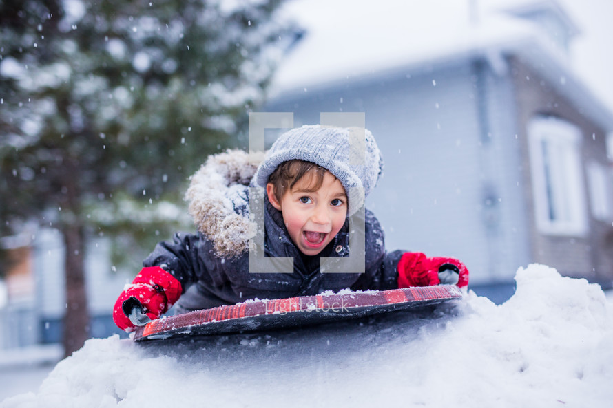 a boy playing in snow 