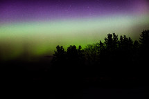 Northern lights penetrate the night sky.