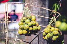 Bags of limes at a fruit stand in Kolkata, India.