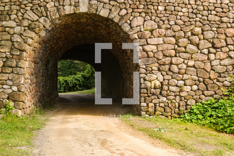tunnel through a stacked stone wall 