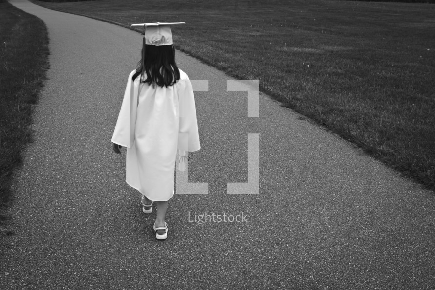 girl carrying a diploma 