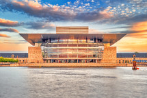 The Copenhagen Opera House in the evening with sunset warm light and colorful clouds