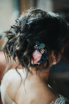 rose in a brides hair 