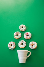 coffee mug and Christmas donuts in the shape of a Christmas tree