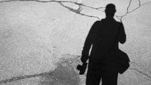 shadow of a man on asphalt 
