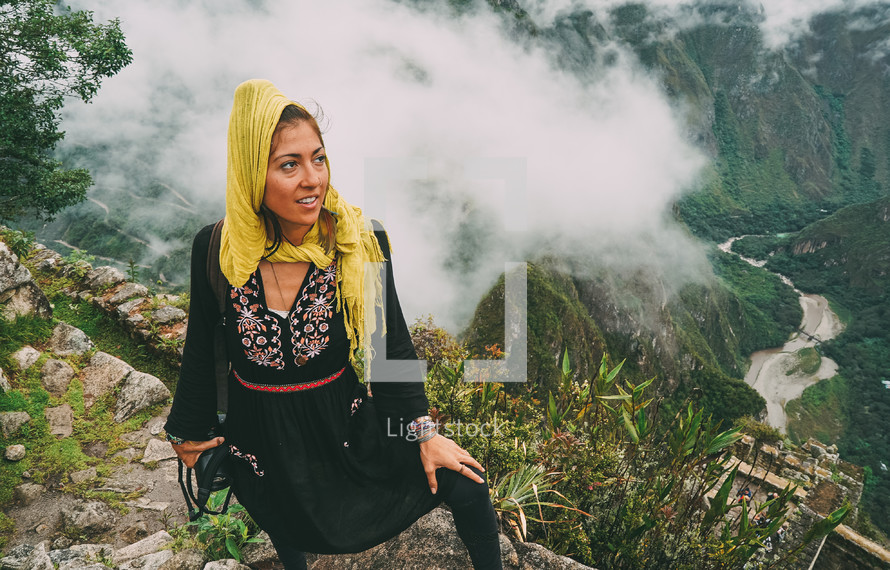 a woman with a camera hiking in Peru 