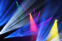 spotlights and stage lights illuminating a vivid colorful background 