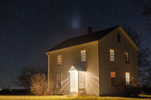 White farmhouse at night