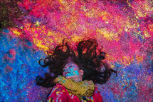 a woman covered in colorful powder 