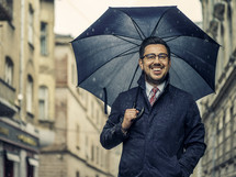 a man holding an umbrella in a city 
