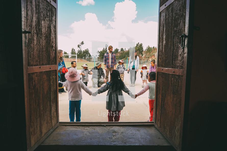 children holding hands in a circle Peru 