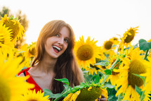 a woman standing in a field of sunflowers 
