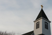 Church steeple and roof with golden cross