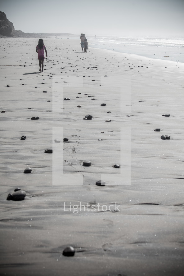 girl child walking on a beach 