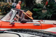 a man in a vintage convertible in Havana, Cuba 