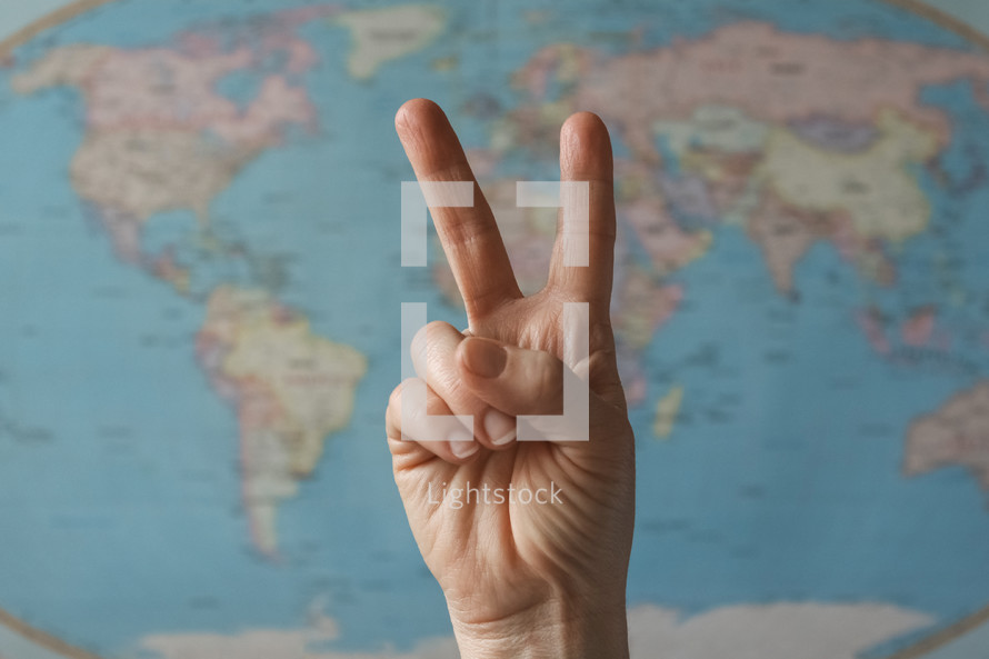 peace sign in front of a world map 