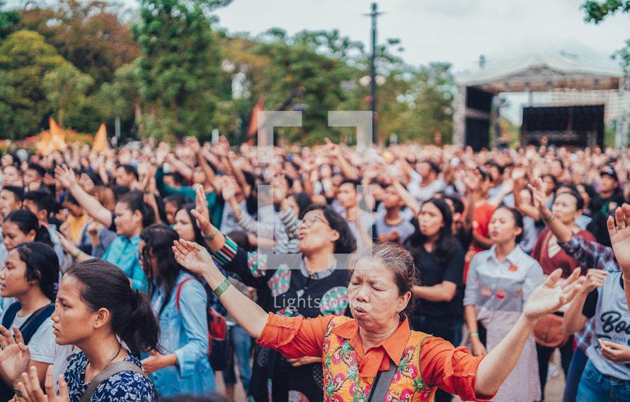 hands raised during a worship serivce 