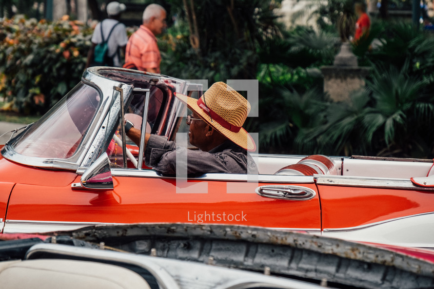 a man in a vintage convertible in Havana, Cuba 