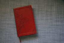red leather Bible on a couch 
