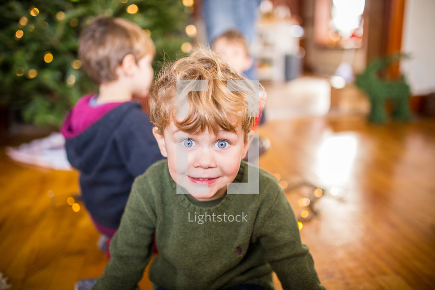 excited children decorating a Christmas tree 