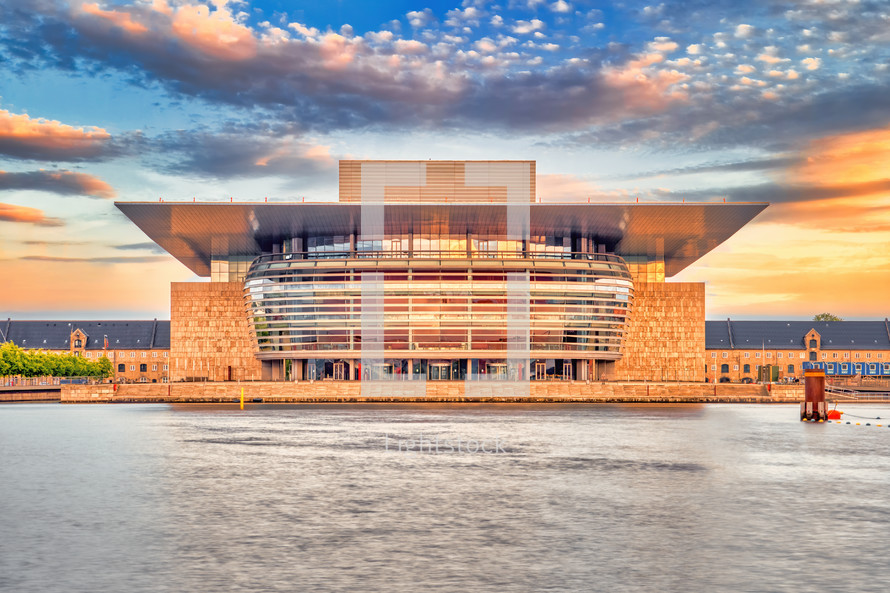 The Copenhagen Opera House in the evening with sunset warm light and colorful clouds