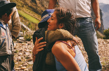 a woman hugging children in Peru 