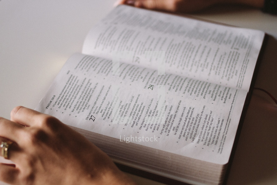 open Bible as a woman reads 