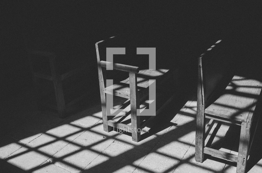 shadow and sunlight on a bench under a pergola 