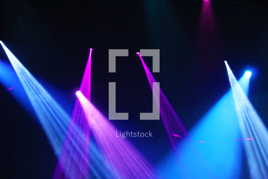 spotlights and stage lights illuminating a vivid colorful background 