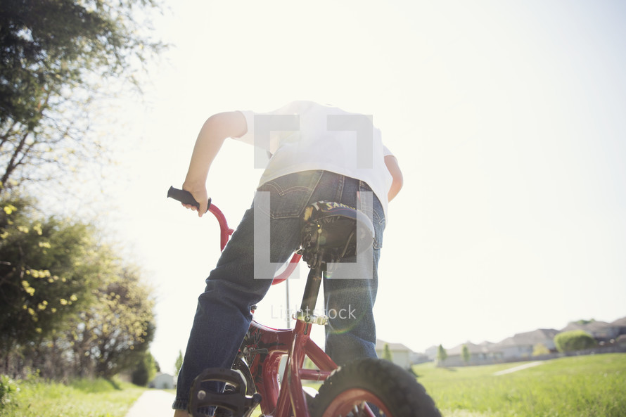 a boy child riding a bike 