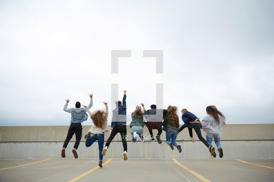 group of teens jumping in celebration 