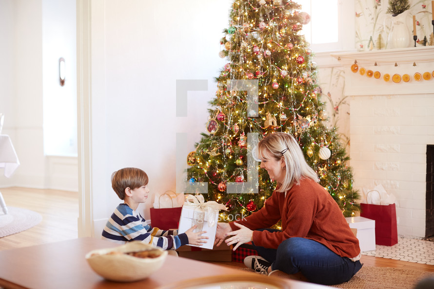 child giving his mother a Christmas present 