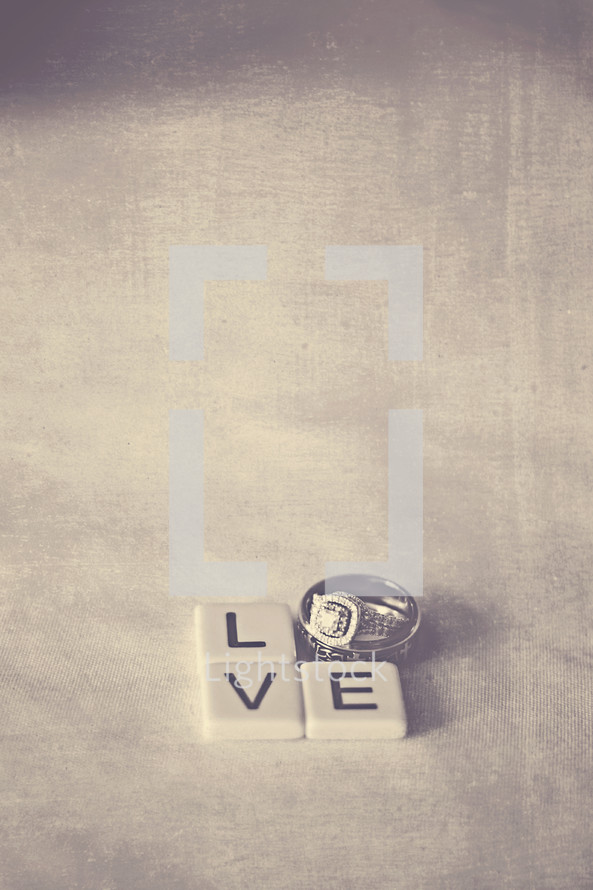 word love in wedding bands and scrabble pieces 