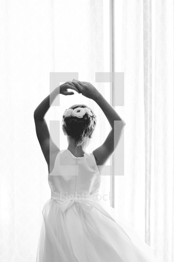 A dancing girl in a white dress.