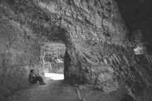 Man sitting in a cavern.