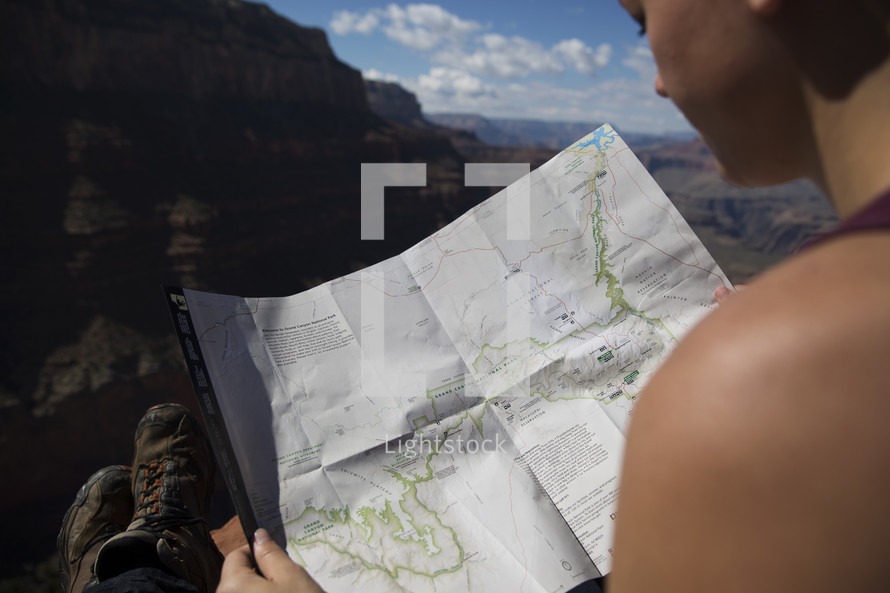 woman looking at a trail map 