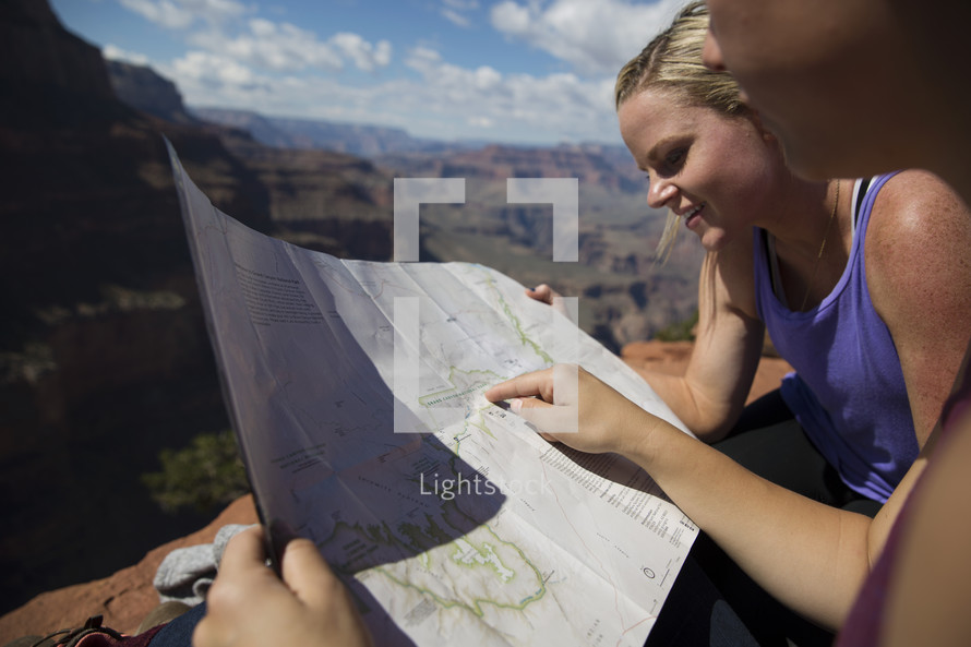 women looking at a trail map 