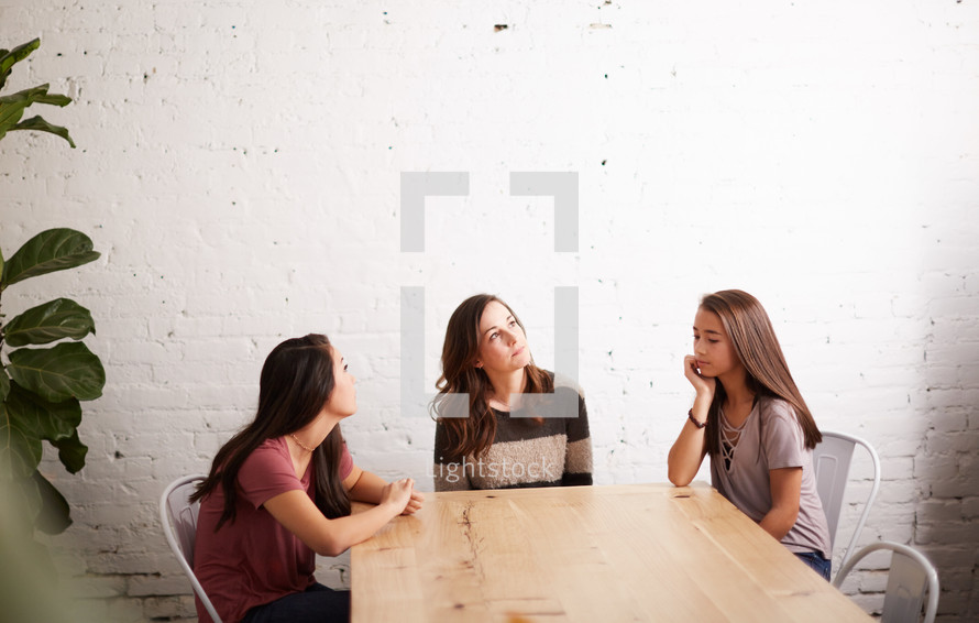 mother and daughters having a conversation 