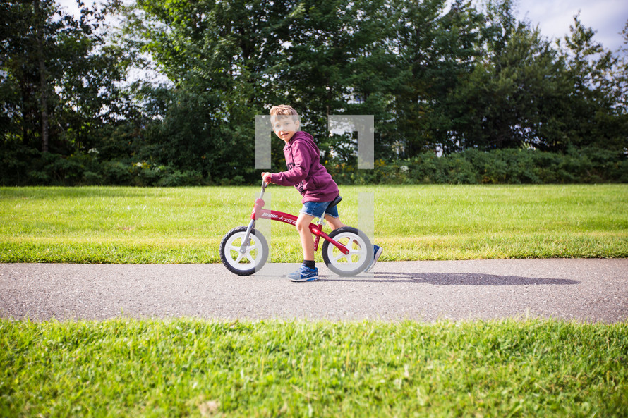a boy on a training bicycle 
