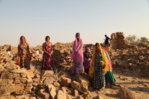 ruins, stacked, piles, stones, rocks, crumbling, walls, women, India, traditional clothing, head scarves 