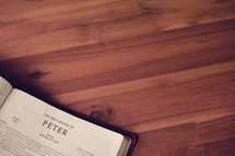BIble on a wood floor opened to Peter 