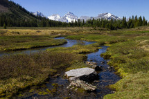 distant mountain peaks and a stream 