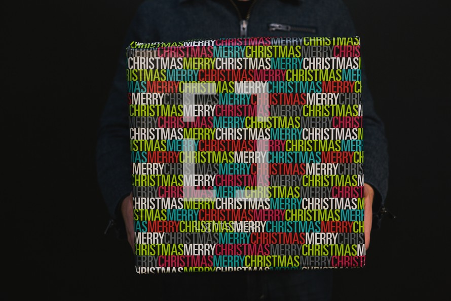 man holding a wrapped Christmas gift 