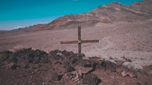 cross in a desert mountain landscape 
