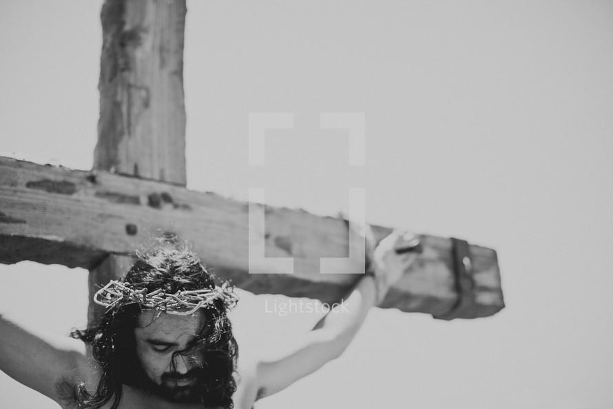 Jesus hanging from the cross with the crown of thorns placed upon his head.